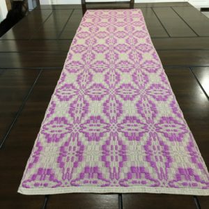 TW Weaving Almond and deep lilac overshot table runner. Reversible. Rayon and cotton. 55" x 14".